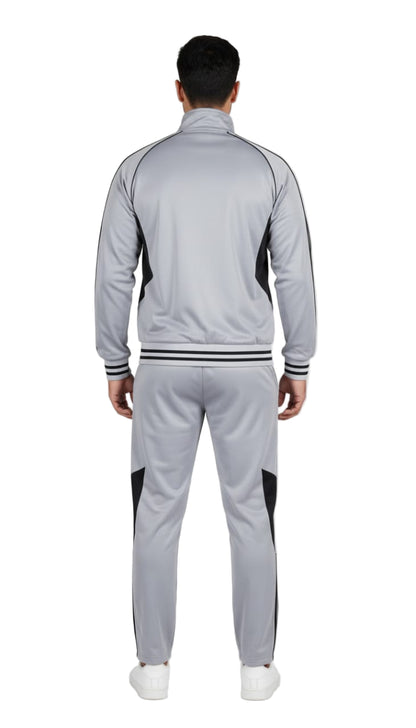 Person wearing a gray tracksuit with black accents on a white background