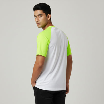 Man wearing a white and green t-shirt on a plain background