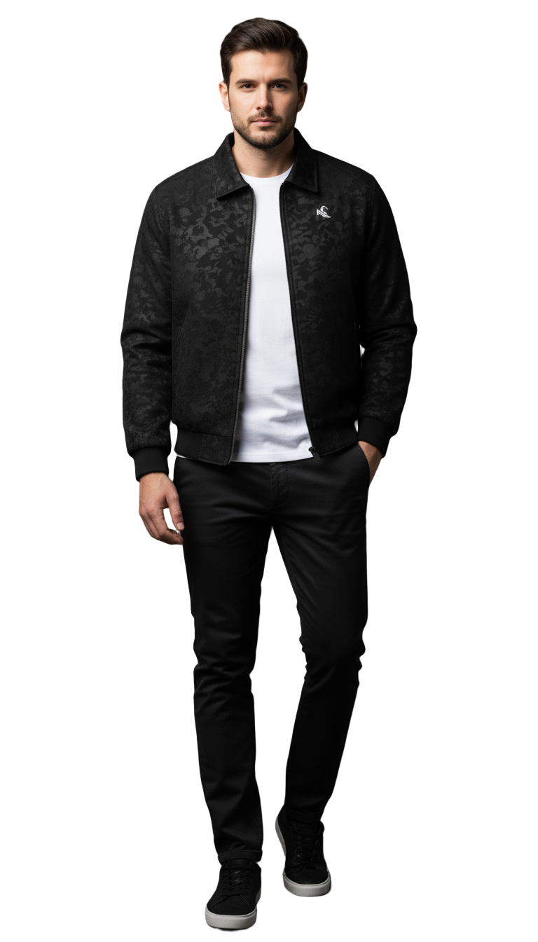 Man wearing a black leather jacket with a white logo, white shirt, and black pants on a gray background