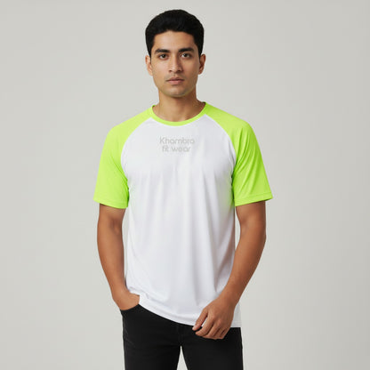 Man wearing a white and green t shirt with 'Khambatta' branding on a gray background