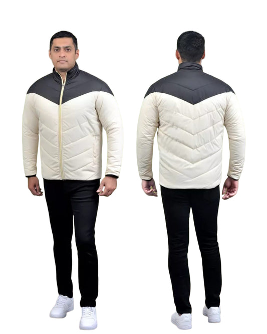 Person wearing a two-tone quilted jacket with black and white colors, standing against a green background.