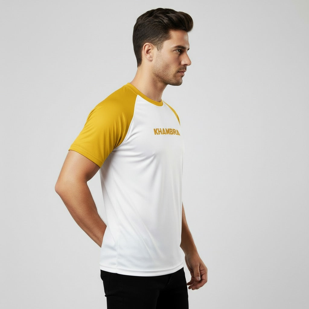 Man wearing a white and yellow sports t shirt with 'Khambra' branding on a light gray background